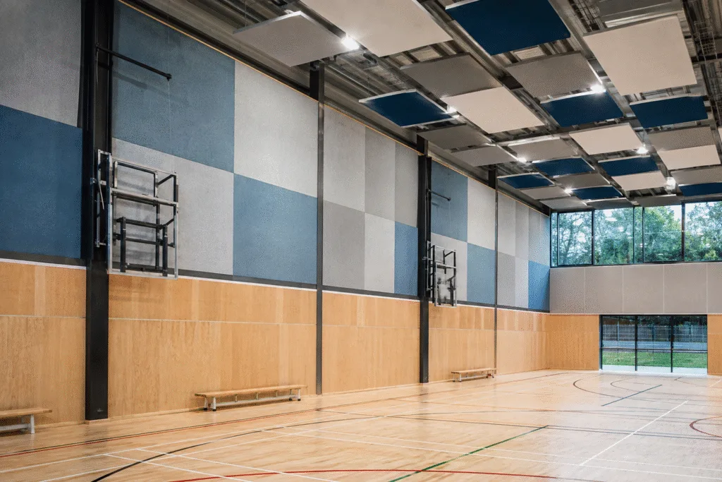 Acoustic wall and ceiling panels installed in a finished school sports hall